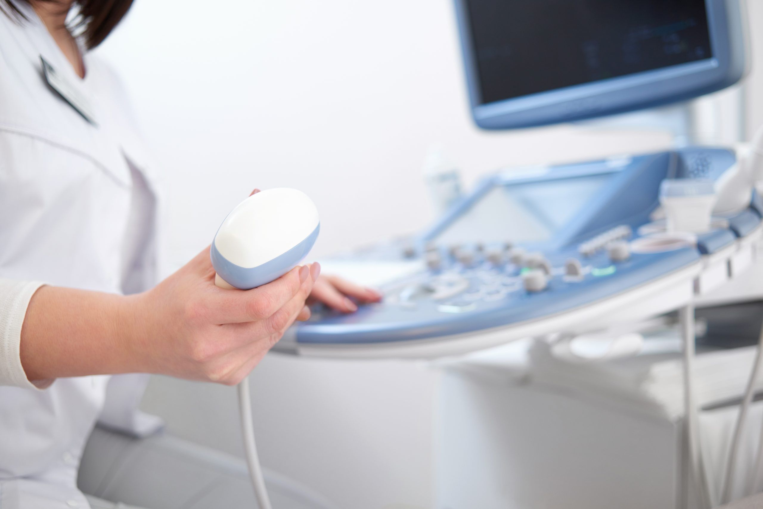 Beautiful female doctor sitting in her office near ultrasound sc Cropped close up of a female doctor holding ultrasound scanner copyspace technology medicine health sonogram scanning vitality hospital clinic professional equipment qualified diagnostics sonography.